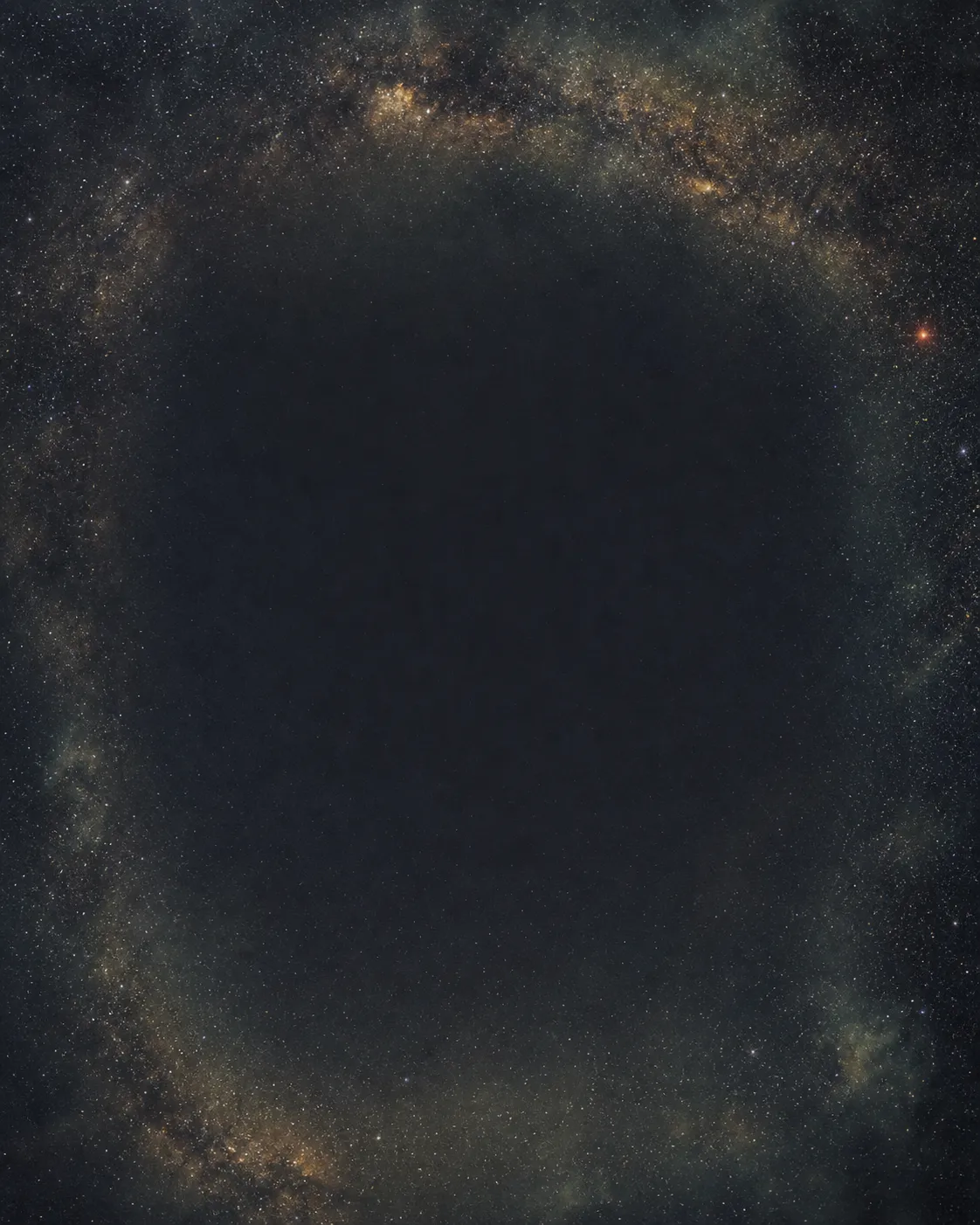 The Milky Way arching in a wide band of stars and dust around a deep, dark centre of sky.